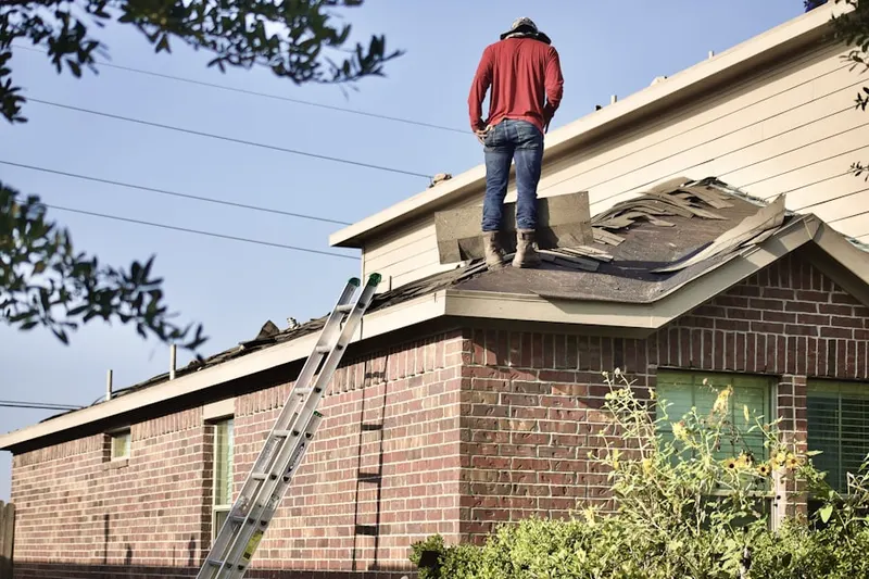 Professional roofer working on a residential roof in Downtown Stamford